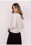 damski sweter w delikatnym odcieniu.webp
